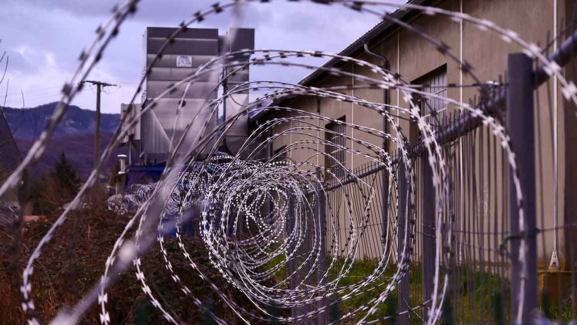 A photo of barbed wire outside a prison.